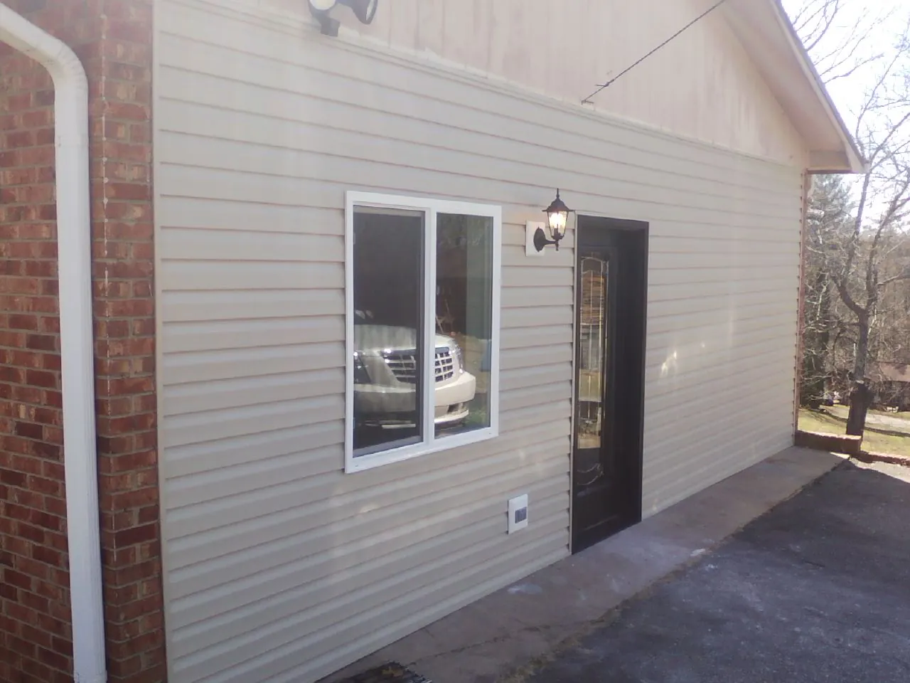 New vinyl siding and entry door on a room addition in Mill Run